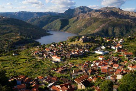 Aerial panoramic view of the historic village of Lindoso, with the surroundings mountains and lake, at the Peneda Geres National Park, in Portugal.